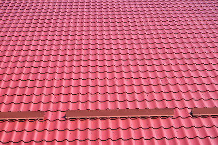 Red metal cover on the roof of the building, background