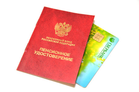 RUSSIA - DECEMBER 17, 2013: A pension certificate and a plastic card of Sberbank of Russia on a white background. Russian text - pension certificate, Sberbankのeditorial素材