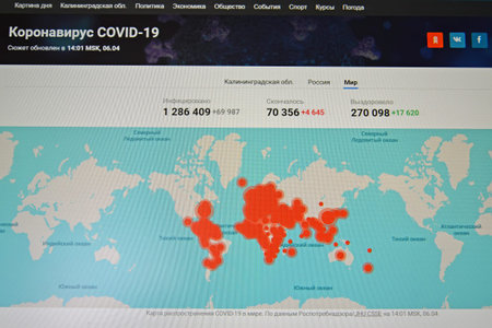 RUSSIA - APRIL 06, 2020: The world 's COVID-19 distribution map on the monitor screen. Coronavirus pandemic in the world. Russian textのeditorial素材