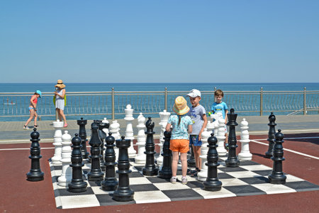 ZELENOGRADSK, RUSSIA - JUNE 25, 2020: Children stand among street chess figures. Kaliningrad regionのeditorial素材