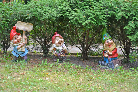 RUSSIA - AUGUST 23, 2020: Three cheerful dwarves. Garden sculpture in the parkのeditorial素材