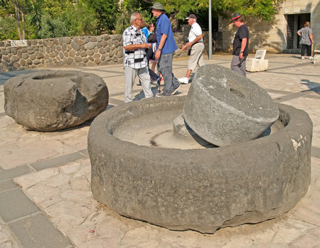 TABHA, ISRAEL - OCTOBER 06, 2012: Ancient millstones on the territory of the Church of the Multiplication of Bread and Fishのeditorial素材