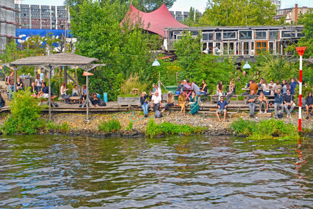 BERLIN, GERMANY - AUGUST 13, 2017: People rest on the bank of the Spree riverのeditorial素材