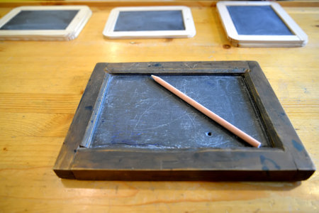 KALININGRAD REGION, RUSSIA - JULY 19, 2020: Griffin boards and a pencil lie on the desk. Museum "Old German School Waldwinkel." Village Ilyichevoのeditorial素材