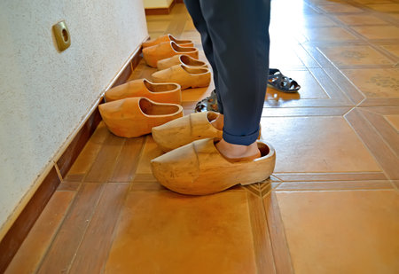 KALININGRAD REGION, RUSSIA - JULY 19, 2020: Legs wrapped in old wooden shoes. Museum "Old German School Waldwinkel." Village Ilyichevoのeditorial素材