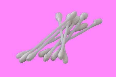 Pile of several white cotton buds with plastic material in isolation on a pink background, the concept of health, beauty, and hygieneの写真素材