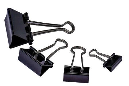 Four black metal paper clips, isolated with a white background, for office, work, school and business conceptsの写真素材