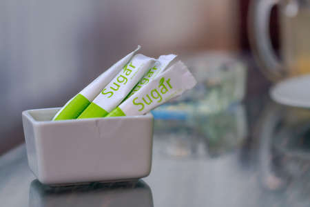 Premium granulated sugar from sugar cane for sweetening is served at the table of a cafe in a tourism area, net weight is 8 gramsのeditorial素材