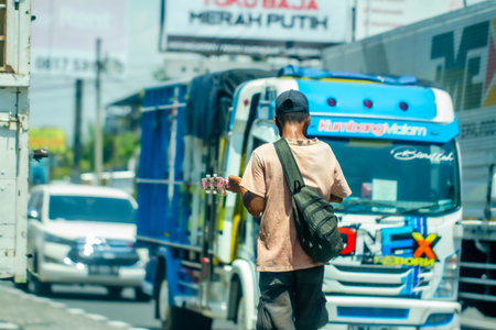 A busker in the area around Prambanan Temple is in action to find small money, during the covid-19...
