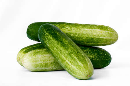 Four cucumbers for greens, in a stack composition, isolated on a white background, copy spaceの写真素材