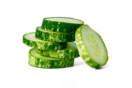 Sliced cucumbers for fresh vegetables, in a stacked composition, isolated on a white background, copy spaceの写真素材