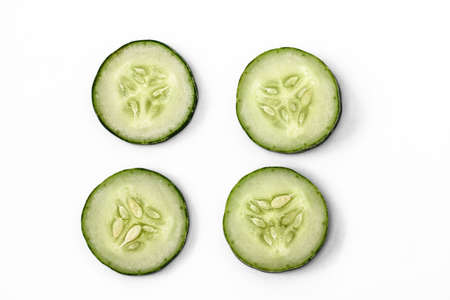 Four slices of cucumber for fresh vegetables, isolated on white background, copy spaceの写真素材