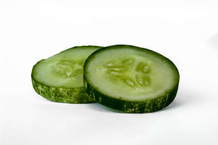 Two slices of cucumber for salad, have composition stacked, isolated on white background, copy spaceの写真素材