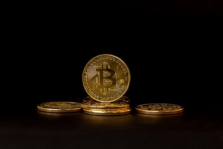 Some Bitcoins that have a gold color are currently popular and have an increasing value compared to the US Dollar. For payment, finance, investment and economy conceptsの写真素材