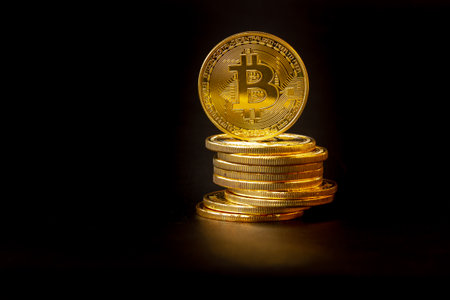 A pile of Bitcoins that have a gold color that is currently popular and has an increasing value compared to the US Dollar. For payment, finance, investment and economy conceptsの写真素材