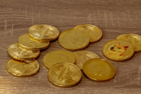 Several types of cryptocurrencies on wooden tables, the value of which is currently increasing and...