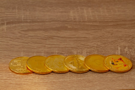 Several types of cryptocurrencies on wooden tables, the value of which is currently increasing and gaining popularity.の写真素材
