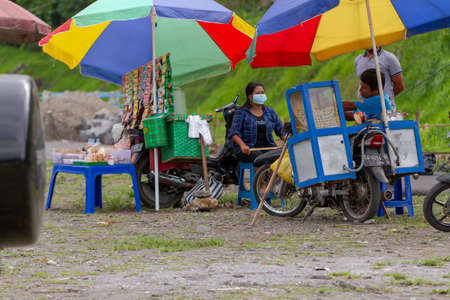 Some traveling vendors seem to be empty of buyers during the coronavirus pandemic. YOGYAKARTA, INDONESIA - OCTOBER 28, 2021.のeditorial素材