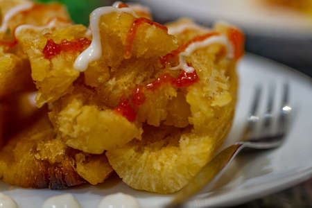 Fried cassava served with cafe-style sauce and mayonnaise, usually consumed with tea or coffee, oily and high-calorieの写真素材