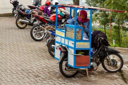 Mobile meatball traders have started operating in the New Selo area, although the area has not been officially opened to the public due to the COVID-19 pandemic. BOYOLALI CENTRAL JAVA, INDONESIA - NOVEMBER 7, 2021.のeditorial素材