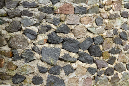 River stone walls with cement adhesive, for a natural nuanced backgroundの写真素材