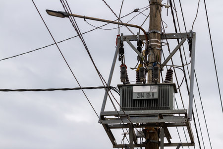 A transformer with concrete poles is used to distribute electric current to several paths, looks confusing cables, the concept of energy and productivityの写真素材