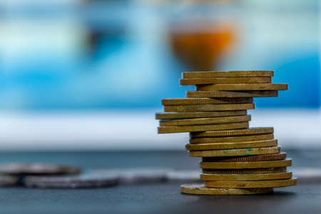 A pile of used gold coins, background blur, financial conceptの写真素材
