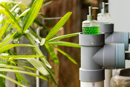 Liquid soap is currently always provided near the water faucet for washing hands, a mandatory habit during the covid-19 pandemic, health conceptの写真素材