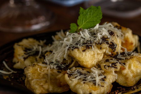 Fried Banana served on a black ceramic plate, a snack for lunch
