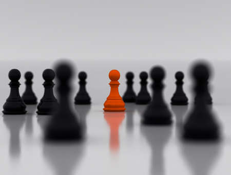 An orange chess piece standing in the middle of another black chess piece, appearing different in the crowd will be the center of attention, 3d illustrationの写真素材