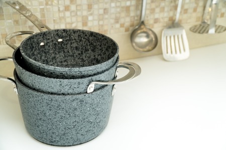 A set of compact storage pans on a kitchen counter. kitchen accessories in the backgroundの写真素材