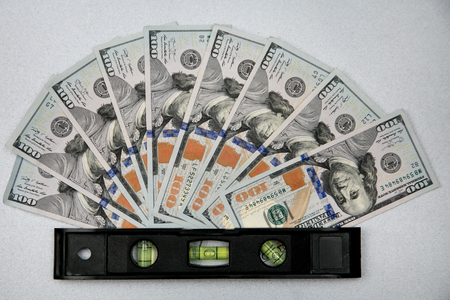 Waterpass and dollars on gray. Money balance. Money levelの写真素材