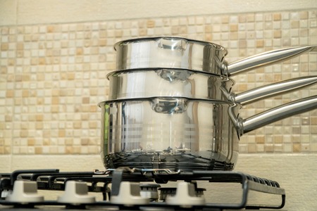 Three big pots in modern kitchen on a gas stoveの写真素材