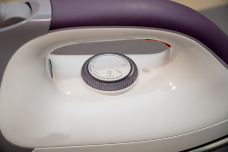Professional iron using in a tailor shop. Woman Ironing Clothes With Electric Iron At Homeの写真素材
