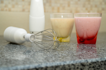 Immersion blender and two glasses of smoothie in a modern kitchen interior. Smoothie Makerの写真素材