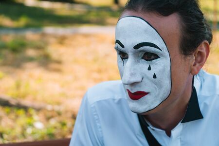 Close-up of a young man mime in a parkの写真素材