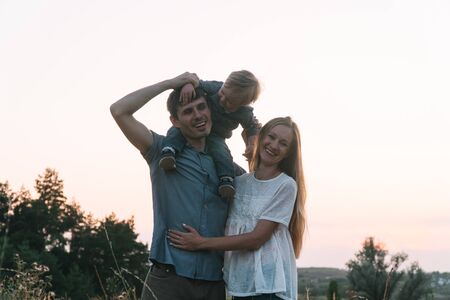 Mother and father with young son fun in the parkの写真素材