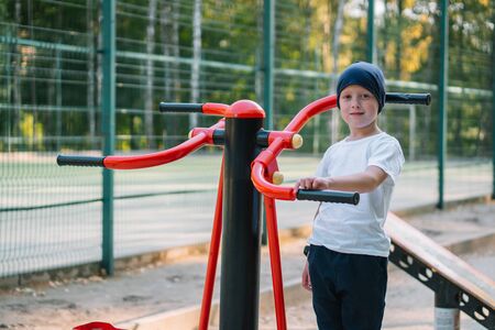 Little boy on street public sports training equipmentの写真素材