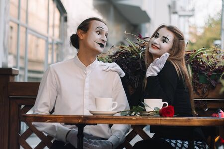 Two happy mime on a date drink coffee in the cafe. Romantic dateの写真素材