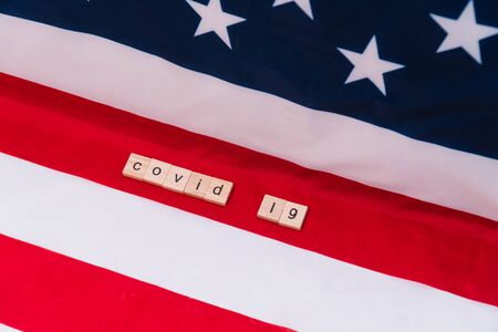 US flag with the inscription covid-19. Coronavirus in the USA. Victory over coronavirus. Covid-19 vaccineの写真素材