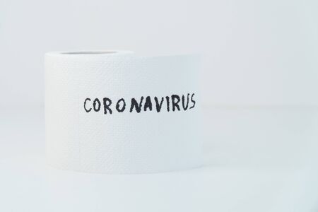 Toilet paper with text coronavirus. Concept of personal hygieneの写真素材
