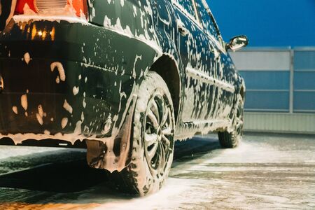 Close up clean car concept at car wash. Washing car with soapの写真素材