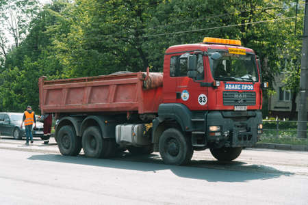 Ternopil, Ukraine, May 2020: Road workers are repairing the road at while road traffic with the use of road equipment. Road worksのeditorial素材