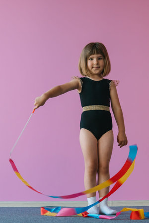 Aesthetics of gymnastics. Pink, black and gold colors. Rainbow ribbon