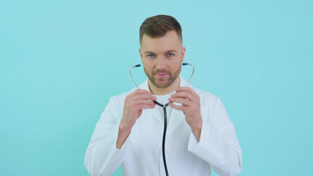 Portrait of a male doctor putting on a stethoscope