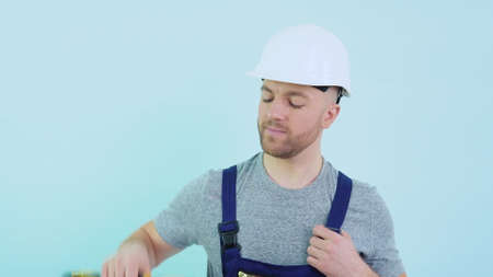Serviceman in overalls showing his toolsの写真素材