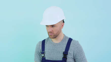 Handyman in overalls holding silicone adhesiveの写真素材