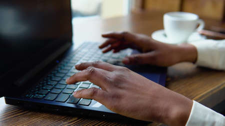 African american businesswoman working on laptop. Hands touch typing pointing cloud data social network mediaの写真素材