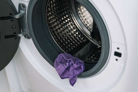 Mens hand clean the washing machine. Detail cleaning concept of washing machine. Stainless drum inside, close-upの写真素材