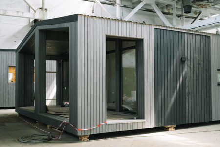 A new wooden modular prefabricated house inside an industrial buildingの写真素材